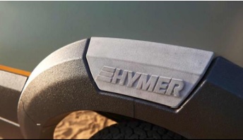 Close-up of 3D printed gray wheel arch with custom Hymer logo.