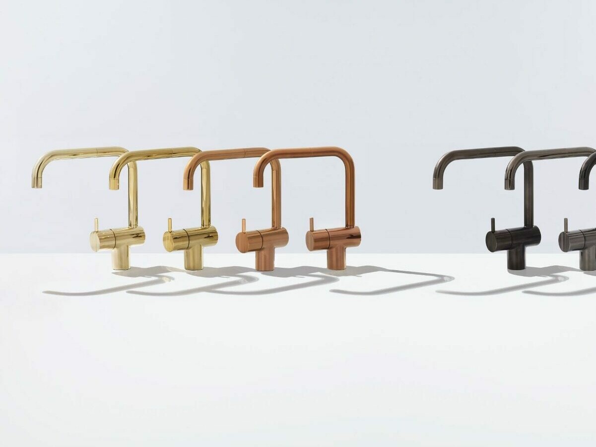 Six design taps in gold, copper and gray tones in a row.