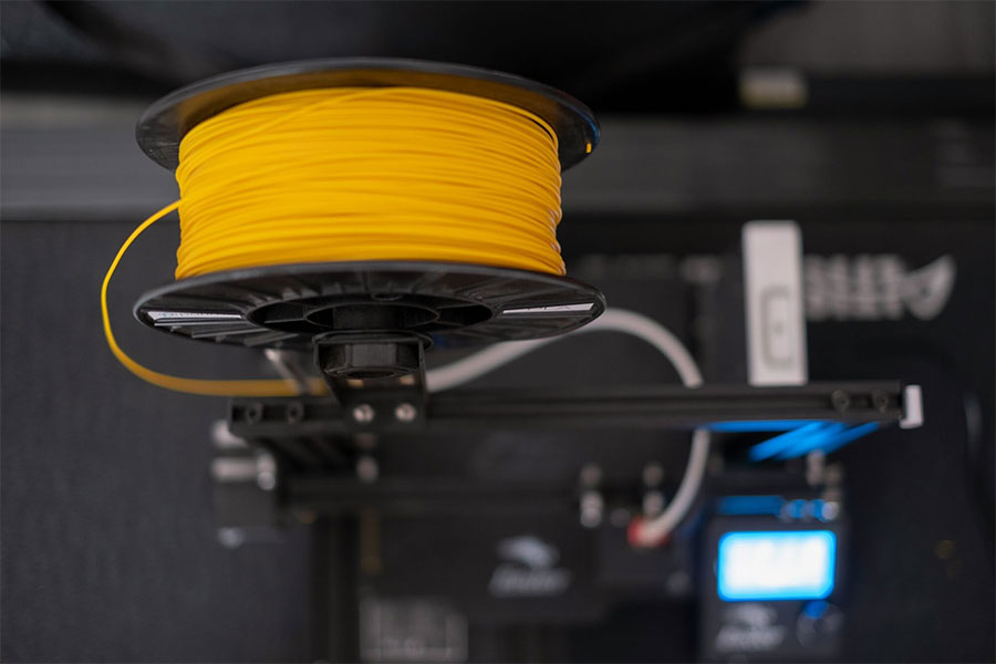 A yellow spool of 3d printing filament from BASF 3D Forward AM